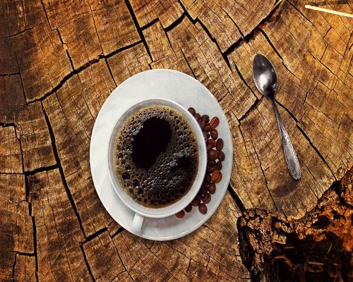 A simple cup of black coffee on a wooden table